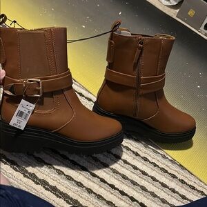 Brown short leather boots with buckle accent